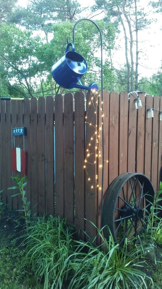 Inspirace na krásnou zahradní dekoraci: Využijte staré konve a světýlka!